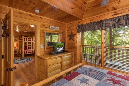 Dresser and TV in a bedroom at Graceland, a 4-bedroom cabin rental located in Pigeon Forge