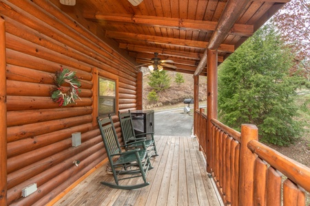 Covered porch with rocking chairs at Let the Good Times Roll, a 2 bedroom cabin rental located in Pigeon Forge