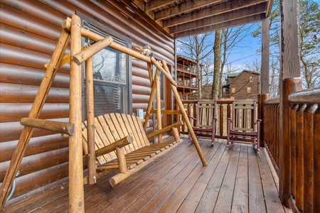 Swing on covered porch at Natural Wonder, a 4 bedroom cabin rental located in Gatlinburg