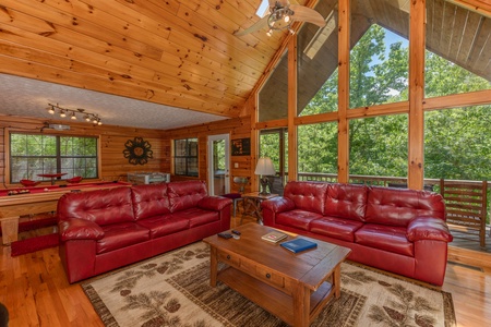 Sofas and large windows in the living room at Hello Dolly, a 1 bedroom cabin rental located in Pigeon Forge