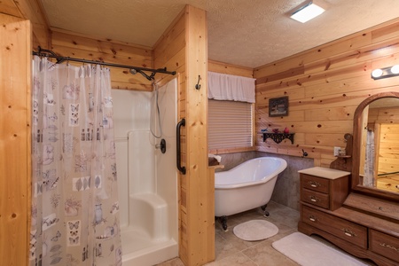 Bathroom with a clawfoot tub and separate shower at Rustic Ranch, a 2 bedroom cabin rental located in Pigeon Forge