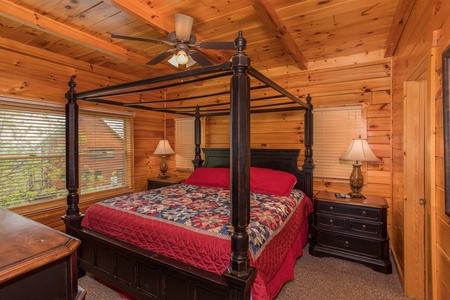 King sized canopy bed at Howlin' in the Smokies, a 2 bedroom cabin rental located in Pigeon Forge