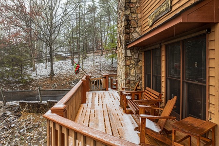 Snowy open deck at Lazy Bear Retreat, with  a 4 bedroom cabin rental located in Pigeon Forge