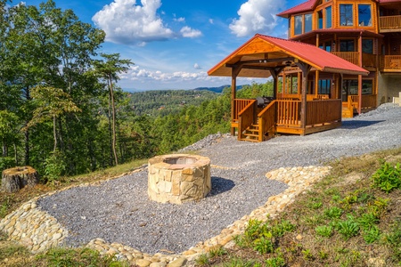 Fire pit in the picnic area at Four Seasons Palace, a 5-bedroom cabin rental located in Pigeon Forge