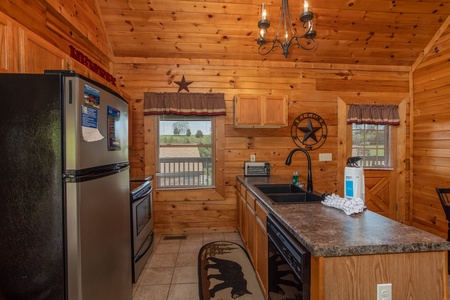 Kitchen with black and stainless appliances at Momma Bear, a 2 bedroom cabin rental located in Pigeon Forge