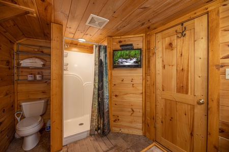 Bathroom with shower and TV at Pigeon Forge Pleasures, a 3 bedroom cabin rental located in Pigeon Forge