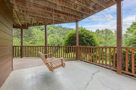 Lower deck porch swing at Almost Bearadise, a 4 bedroom cabin rental located in Pigeon Forge