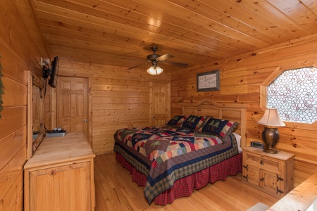 Bedroom with a night stand, dresser, and a TV