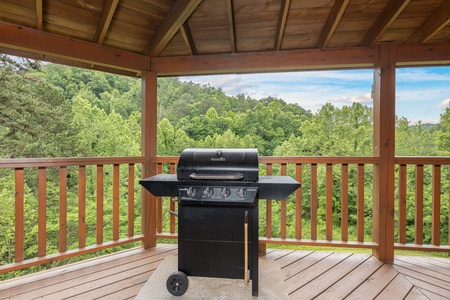 Grill on a covered deck at Almost Bearadise, a 4 bedroom cabin rental located in Pigeon Forge