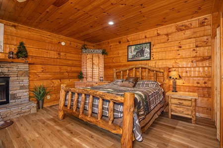Log bed at Mountain Magic, a 1 bedroom cabin rental located in Pigeon Forge