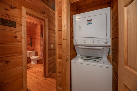 Stacked washer and dyer at Logan's Smoky Den, a 2 bedroom cabin rental located in Pigeon Forge