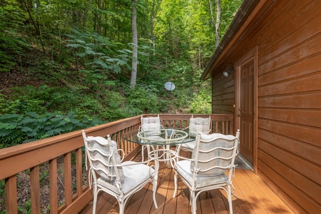 Outdoor dining set for four at Hawk's Heart Lodge, a 3 bedroom cabin rental located in Pigeon Forge