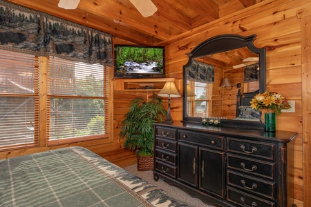 Dresser, mirror, and TV in a bedroom at 1 Above the Smokies, a 2 bedroom cabin rental located in Pigeon Forge