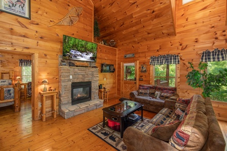 Fireplace and TV in the living room at Misty Mountain Escape, a 2 bedroom cabin rental located in Gatlinburg