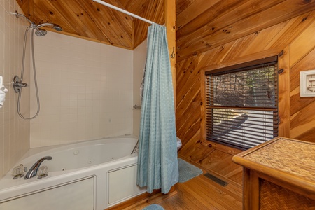 Bathroom with a shower and jacuzzi at Hatcher Mountain Retreat a 2 bedroom cabin rental located in Pigeon Forge