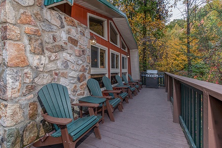 Gas grill and seating on the deck at Without A Paddle, a 3 bedroom cabin rental located in Gatlinburg