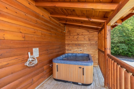 Hot tub on a covered deck at Majestic Sunrise, a 1 bedroom cabin rental located in Pigeon Forge