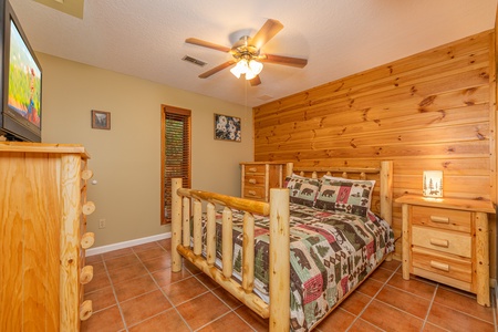 King bedroom with TV at Copper Owl, a 2 bedroom cabin rental located in Pigeon Forge