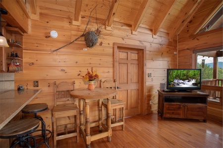 Dining space shared with the living room at Cedar Creeks, a 2-bedroom cabin rental located near Douglas Lake