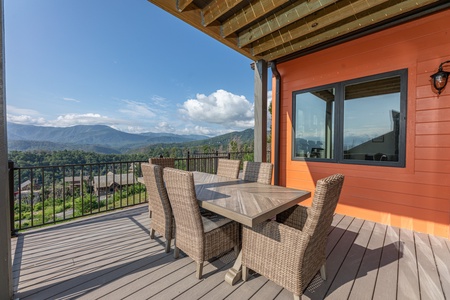 Dining space on the deck at Mountain Celebration, a 4 bedroom cabin rental located in Gatlinburg