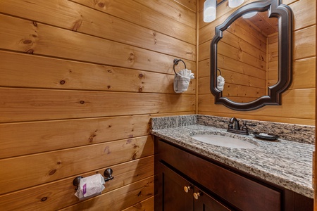 Bathroom sink and mirror at Four Seasons Grand, a 5 bedroom cabin rental located in Pigeon Forge