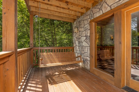 Porch swing at Cub's Crossing, a 3 bedroom cabin rental located in Gatlinburg