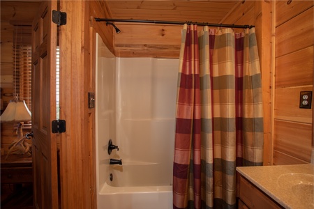Bathroom with a tub and shower at Cedar Creeks, a 2-bedroom cabin rental located near Douglas Lake