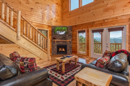 Fireplace and TV in a living room at Canyon Camp Falls, a 2 bedroom cabin rental located in Pigeon Forge