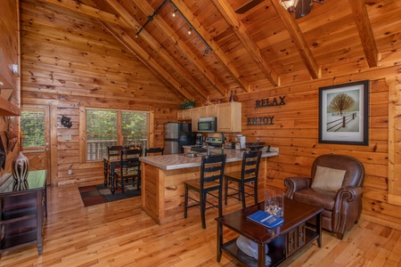 Kitchen with breakfast bar and dining space at Majestic Sunrise, a 1 bedroom cabin rental located in Pigeon Forge