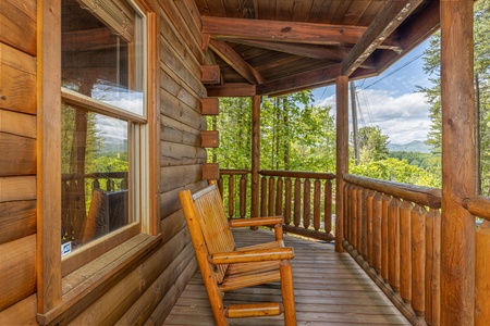 Bench on a covered deck at Moonlit Pines, a 2 bedroom cabin rental located in Pigeon Forge