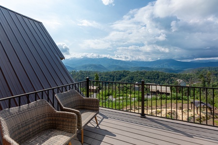 Deck with two chairs at Mountain Celebration, a 4 bedroom cabin rental located in Gatlinburg