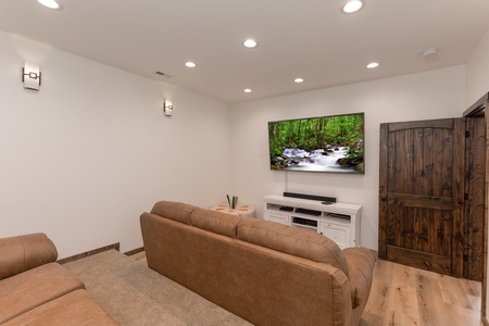 TV in the theater room at Mountain Celebration, a 4 bedroom cabin rental located in Gatlinburg