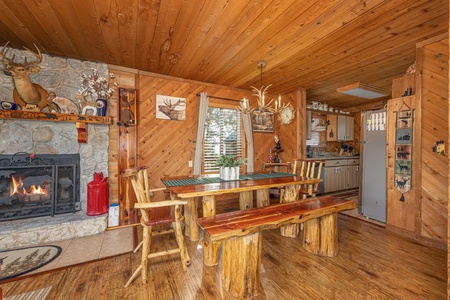 Dining space with seating for six next to the fireplace at Bearing Views, a 3 bedroom cabin rental located in Pigeon Forge