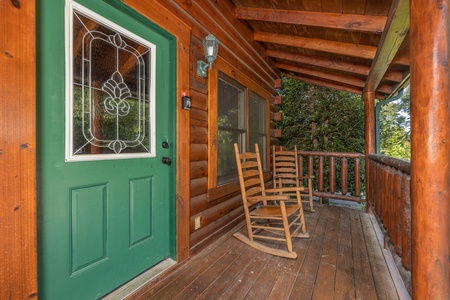 Front door on a covered deck at Family Getaway, a 4 bedroom cabin rental located in Pigeon Forge