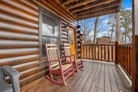 Covered deck and seating at Natural Wonder, a 4 bedroom cabin rental located in Gatlinburg