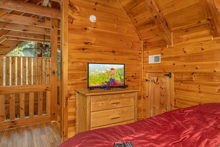 Bedroom with a dresser and TV at Walkin' To Gatlinburg, a 2 bedroom cabin rental located in Gatlinburg