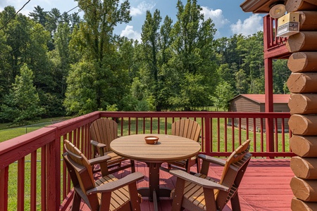 Dining table on the deck at 1 Crazy Cub, a 4 bedroom cabin rental located in Pigeon Forge