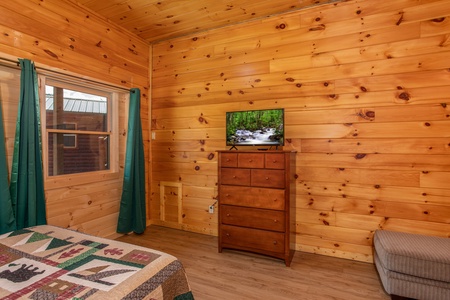 Flat screen TV on a dresser at Cabin Fever, a 4-bedroom cabin rental located in Pigeon Forge