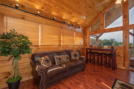 Sofa and bar set in the game loft at 1 Above the Smokies, a 2 bedroom cabin rental located in Pigeon Forge