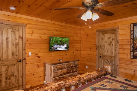 Bedroom with a tv and dresser at Four Seasons Palace, a 5-bedroom cabin rental located in Pigeon Forge
