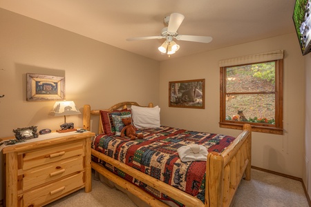Bedroom with a log bed and night stand at Lazy Bear Retreat, a 4 bedroom cabin rental located in Pigeon Forge