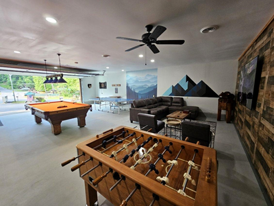 Gaming area with foosball, pool, and sectional at Moonlit Mountain Lodge
