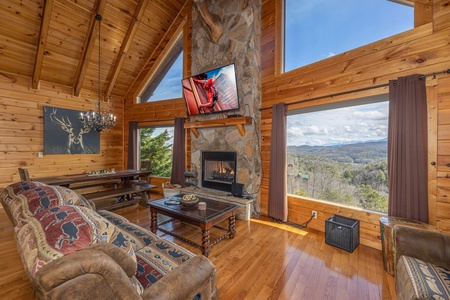 Living room with TV and fireplace at Mountain Mama, a 3 bedroom cabin rental located in Pigeon Forge
