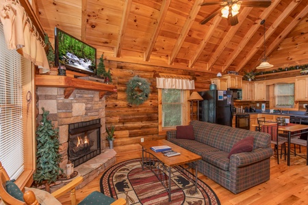 living room sofa seating near the fireplace at alpine sunset thrill a 1 bedroom cabin rental located in pigeon forge