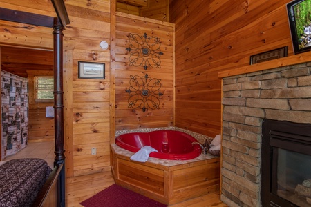 Heart shaped jacuzzi in the bedroom at Majestic Sunrise, a 1 bedroom cabin rental located in Pigeon Forge