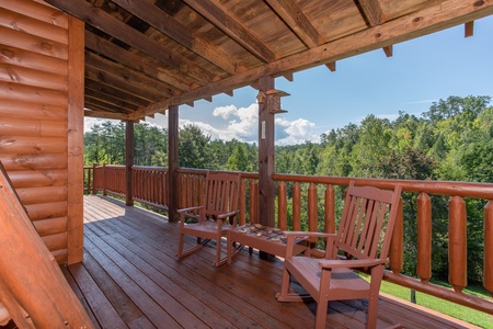 Rocking chairs on a covered deck at Cabin Fever, a 4-bedroom cabin rental located in Pigeon Forge