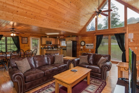 Living room with seating and vaulted ceiling at Family Ties Lodge
