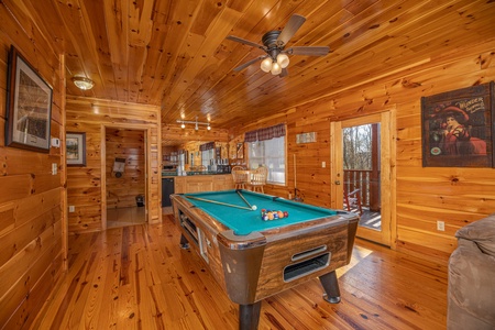 Pool table in the lower living room at Hickernut Lodge, a 5-bedroom cabin rental located in Pigeon Forge
