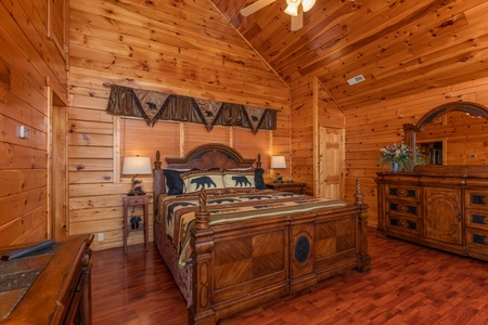 Bedroom with a king bed, two end tables, lamps, and a dresser at 1 Above the Smokies, a 2 bedroom cabin rental located in Pigeon Forge
