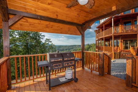 Propane grill on a covered deck at Four Seasons Palace, a 5-bedroom cabin rental located in Pigeon Forge